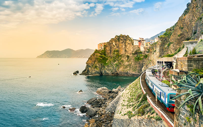 Train driving on cliff face of Europe