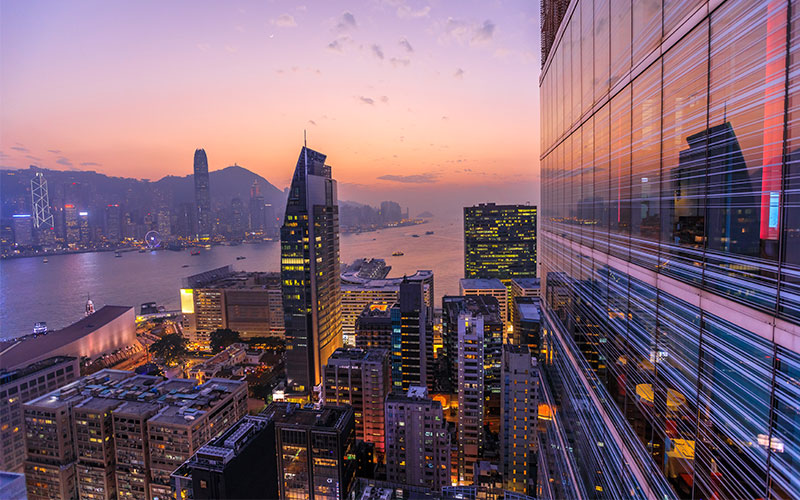 Purple skies over Hong Kong skyscrapers and mountains