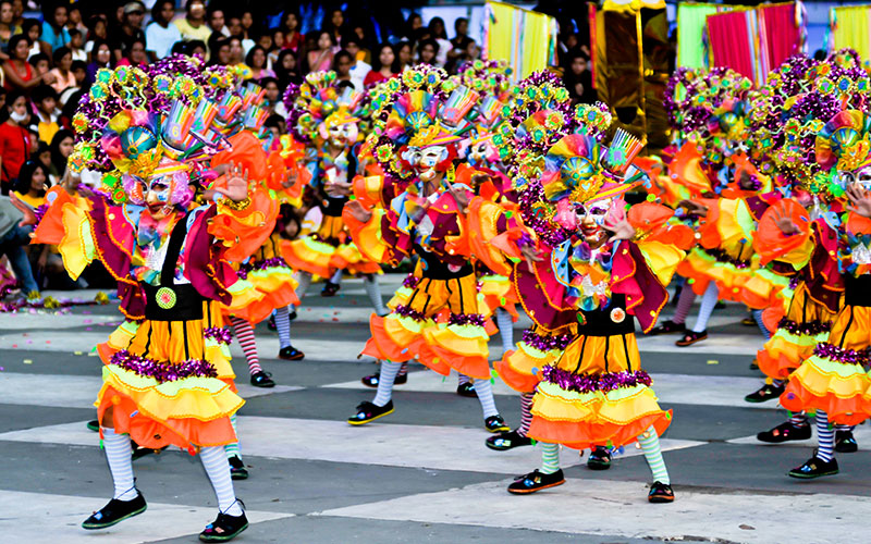 Masked dancers in the streets of Bacolod during the MassKara Festival, The Philippines