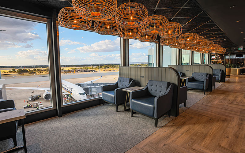 Seating area in Perth Airport Aspire Lounge T1 overlooking Singapore Airlines aeroplane