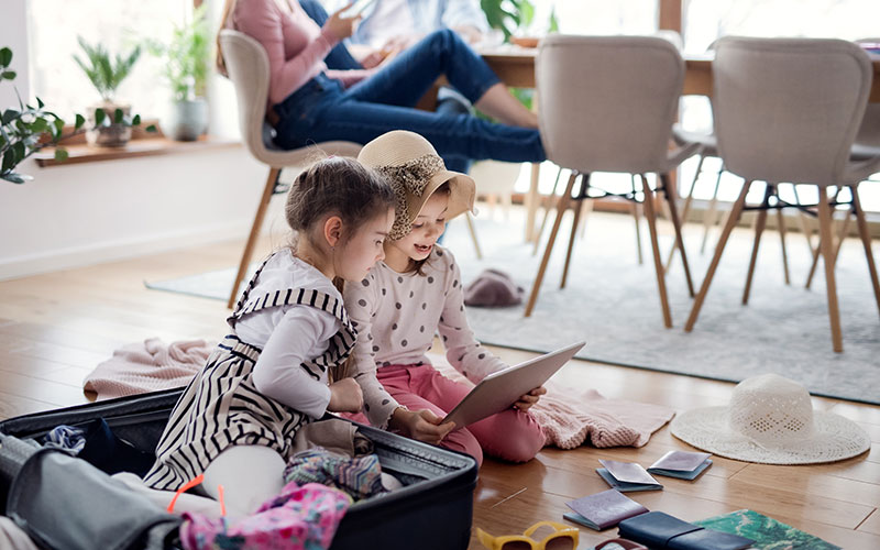 Two girls playing in suitcase