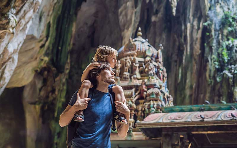 Father and son in the background of Batu Caves