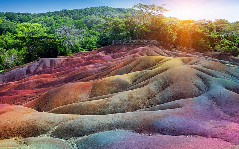 Natural rainbow on Chamarel Coloured Earth with forest in background