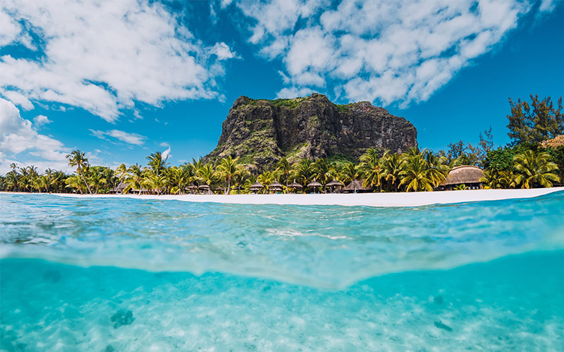 Crystal clear waters with beach shore in background