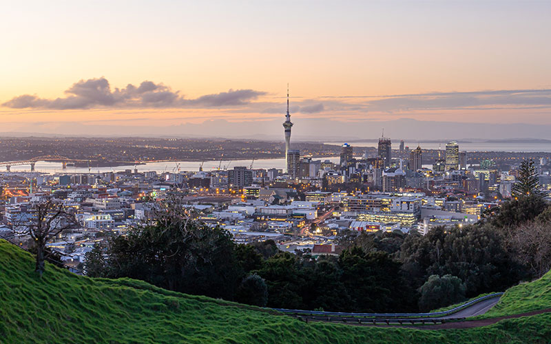 Aukland’s city skyline ablaze at sunset from Mt Eden, New Zealand