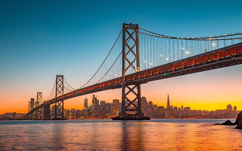 The San Francisco–Oakland Bay Bridge aglow at sunset.
