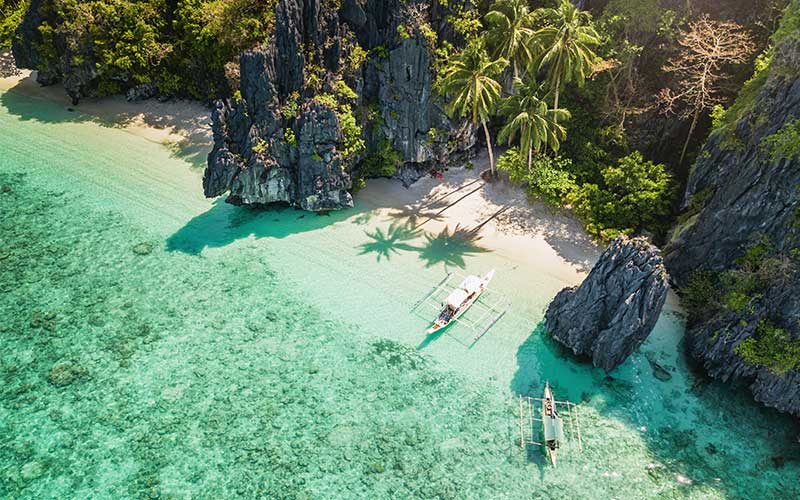 Filipino Balangay boats on Entalula Island Beach Lagoon, Palawan, Philippines