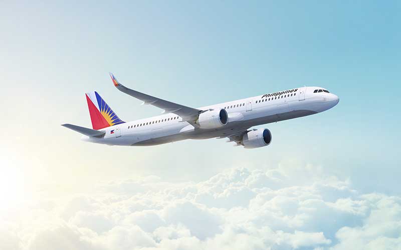 Philippine Airlines aeroplane flying above clouds