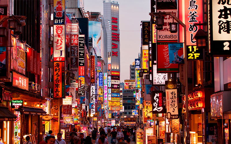 Tokyo's city centre in the evening with illuminated signs and billboards