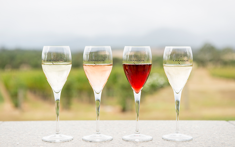 Glasses of wine on ledge overlooking vineyard at Chandon Winery