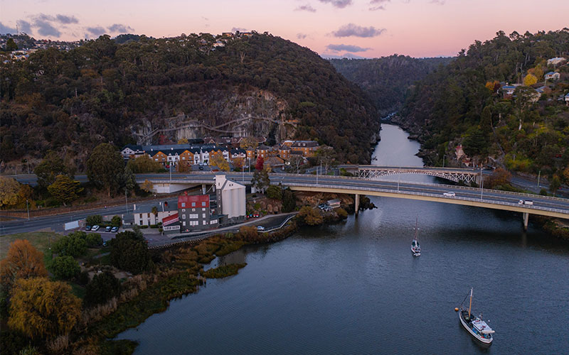 Kings Bridge over river at Cataract Gorge Reserve at sunset