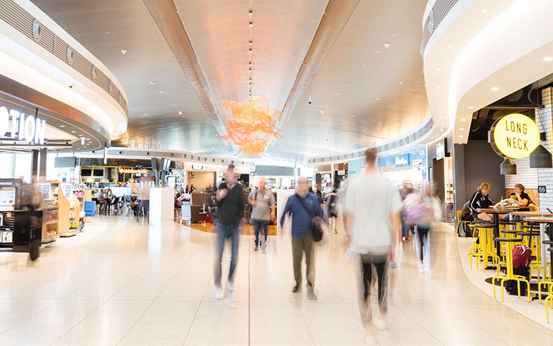 Passengers walking around eateries in Terminal 1 Domestic